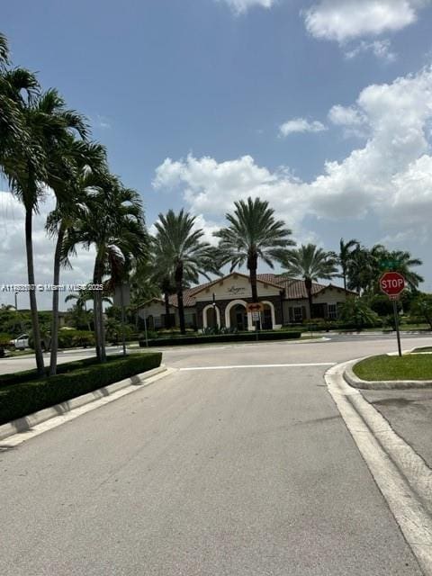 view of street featuring traffic signs and curbs