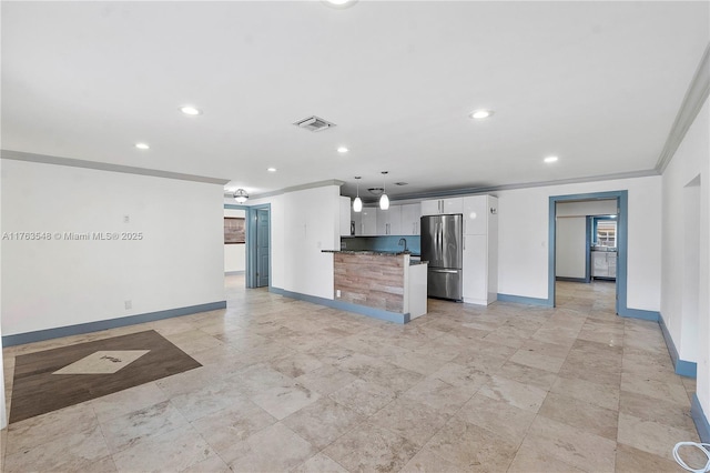 unfurnished living room featuring crown molding, recessed lighting, and baseboards