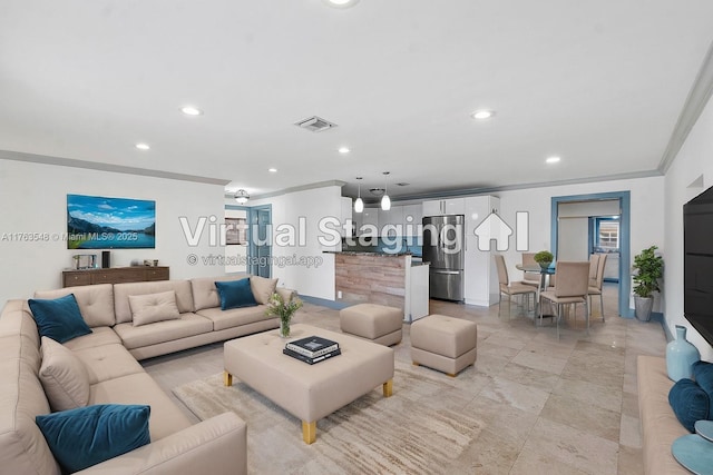 living room featuring visible vents, recessed lighting, and ornamental molding