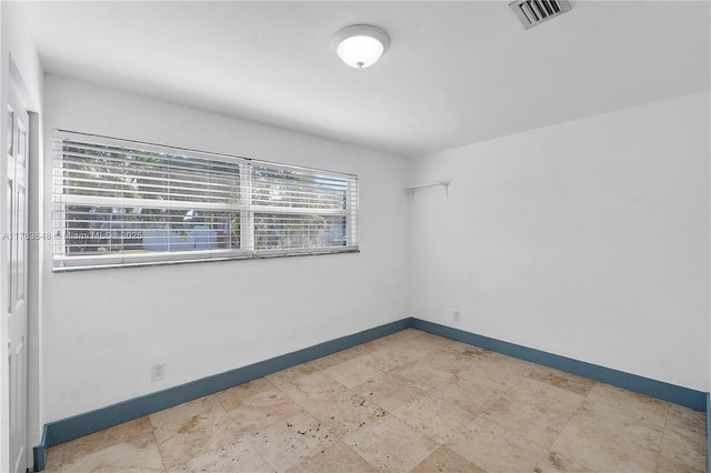 empty room with visible vents and baseboards