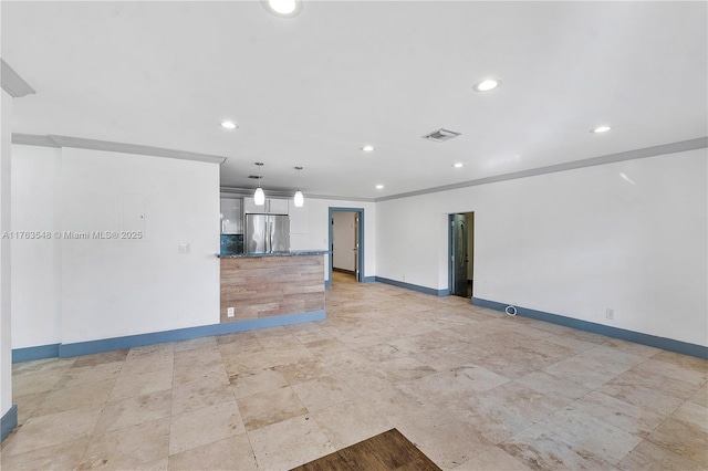 unfurnished living room with recessed lighting, visible vents, baseboards, and crown molding