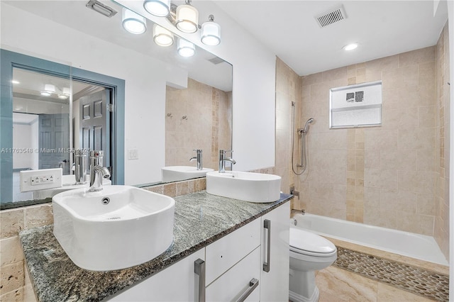 full bathroom featuring visible vents, toilet, and a sink