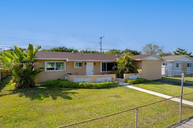 ranch-style home featuring stucco siding, a front yard, and fence