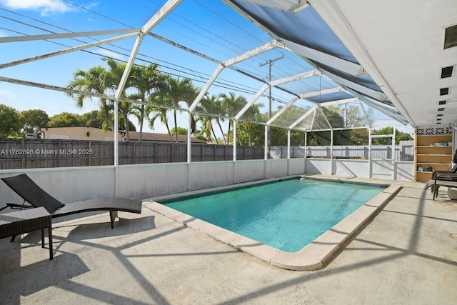 view of pool with a lanai, a fenced backyard, and a patio area