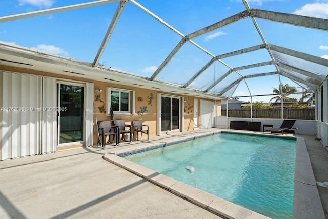 view of pool with a fenced in pool, a patio, a lanai, and fence