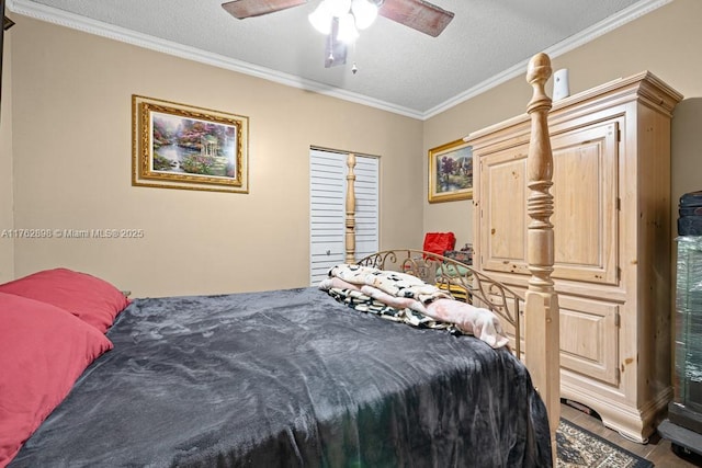 bedroom with a textured ceiling, ceiling fan, and ornamental molding