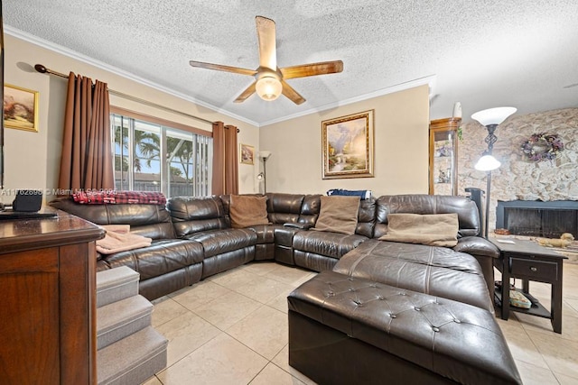 living area featuring light tile patterned flooring, a textured ceiling, ornamental molding, and a ceiling fan