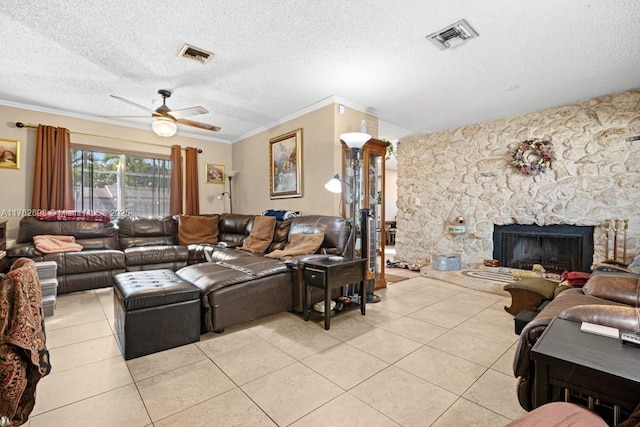 living area featuring light tile patterned floors, visible vents, crown molding, and a ceiling fan