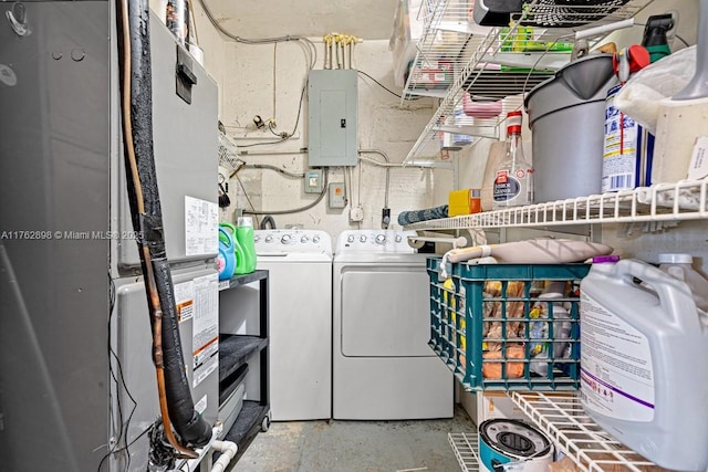 washroom featuring heating unit, laundry area, electric panel, and independent washer and dryer