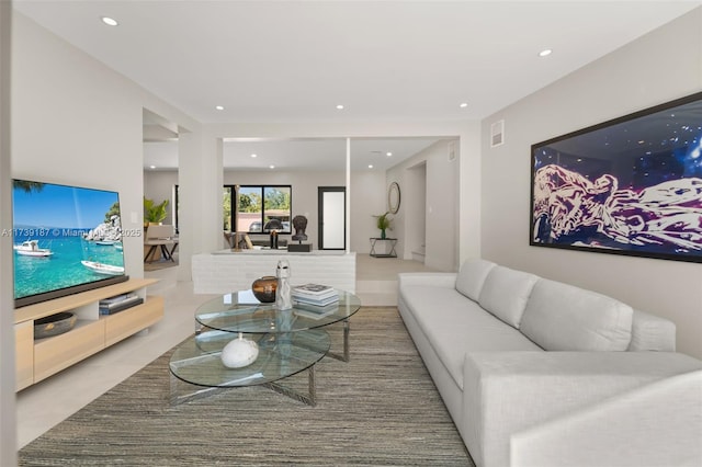 living area with recessed lighting and visible vents