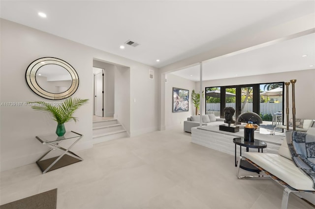 living area featuring recessed lighting and visible vents