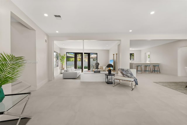 living area featuring recessed lighting and visible vents