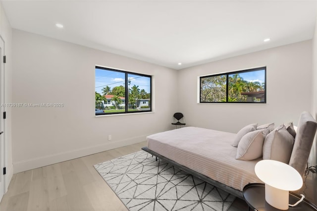 bedroom featuring recessed lighting, light wood-type flooring, and baseboards