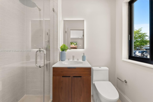 full bathroom featuring toilet, a stall shower, and vanity