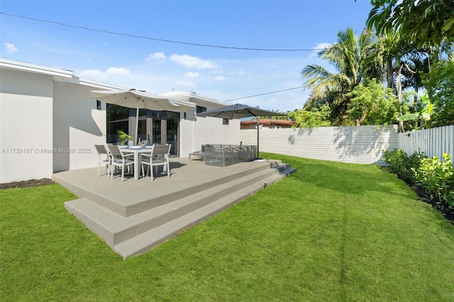 view of yard featuring a patio area and a fenced backyard