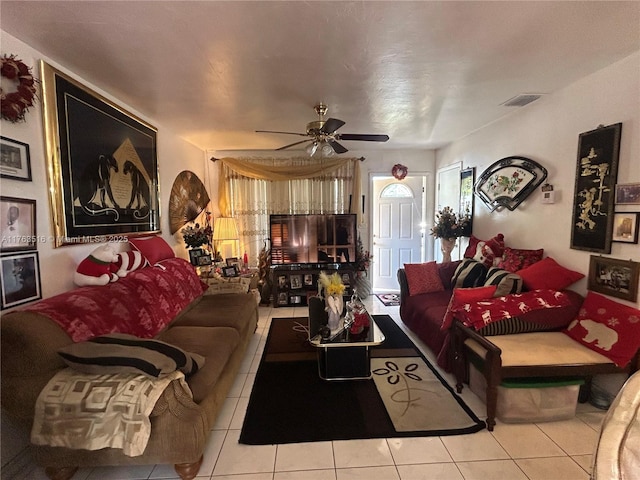 living room with tile patterned flooring, visible vents, and ceiling fan