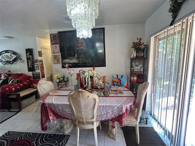 tiled dining room with visible vents and a chandelier