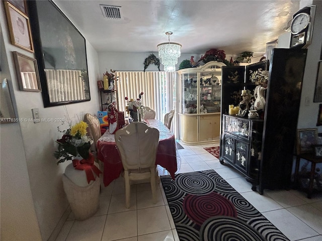 dining space featuring an inviting chandelier, light tile patterned floors, and visible vents