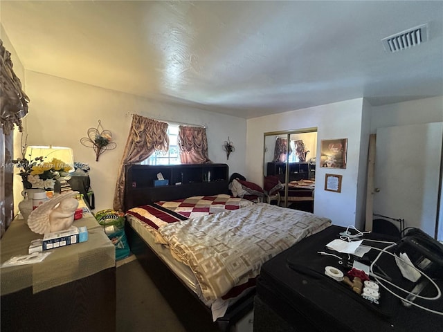 bedroom featuring visible vents and a closet