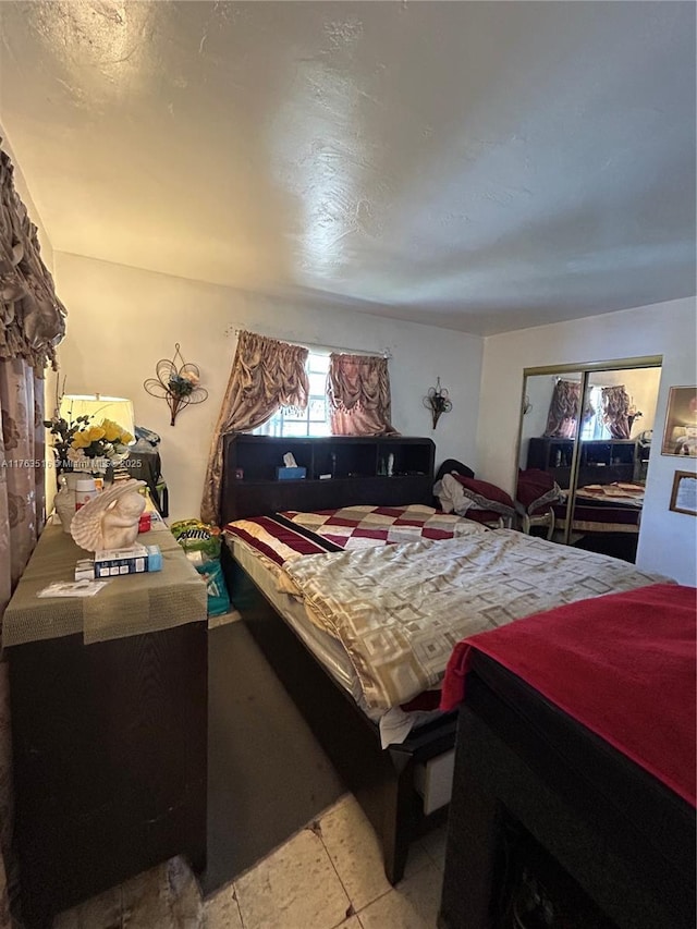 bedroom featuring light tile patterned floors