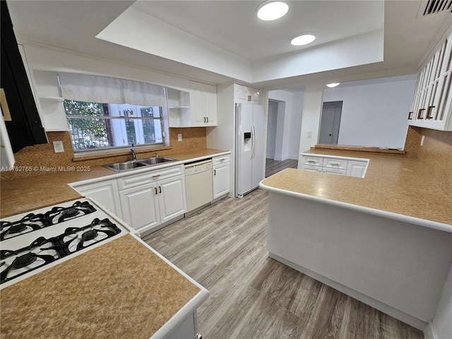 kitchen with visible vents, a sink, white cabinets, white appliances, and open shelves