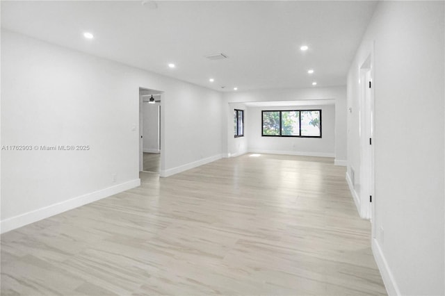 unfurnished room with recessed lighting and baseboards