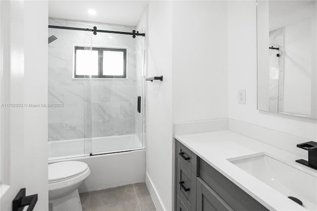 full bath with vanity, toilet, and bath / shower combo with glass door