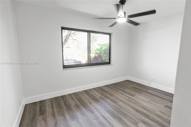 unfurnished room featuring wood finished floors, baseboards, and ceiling fan