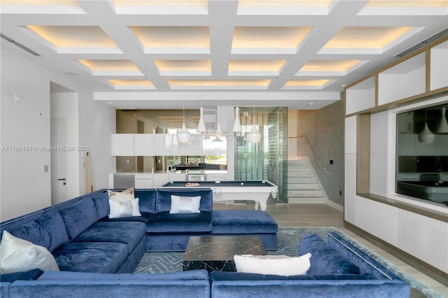 living area featuring stairway, beam ceiling, visible vents, and wood finished floors