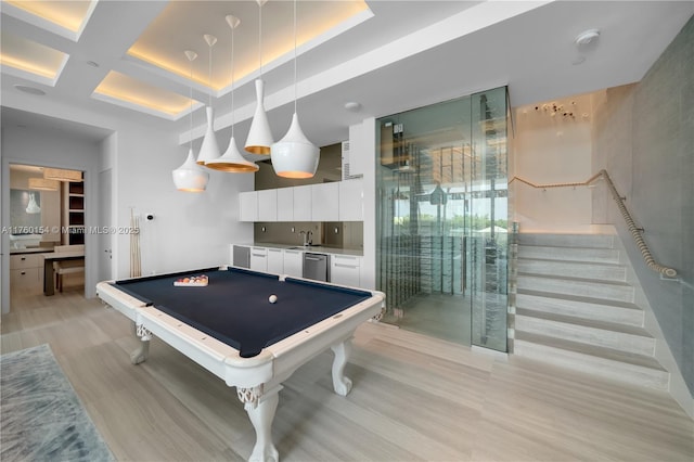 recreation room featuring indoor wet bar, light wood-style floors, coffered ceiling, billiards, and a sink