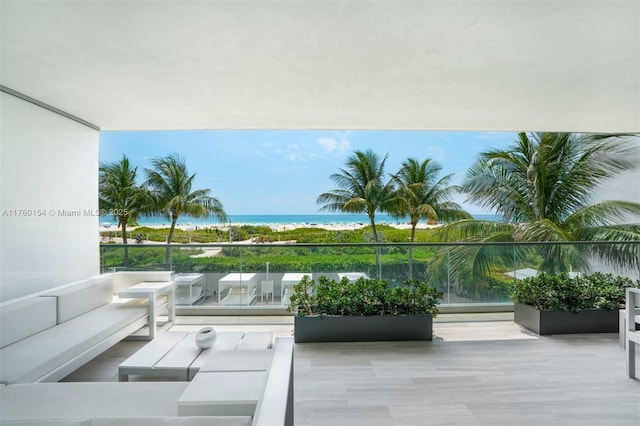 view of patio featuring a balcony and a water view