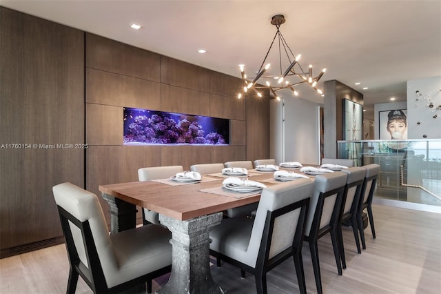 dining room featuring recessed lighting, a notable chandelier, and light wood finished floors