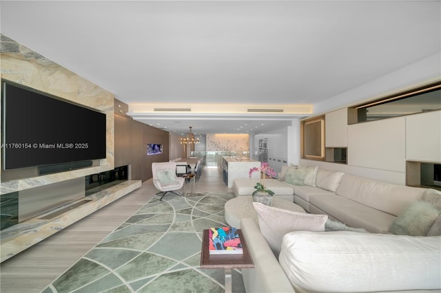 321 Ocean Dr Unit 200, Miami Beach, FL 33139 - living room with light wood finished floors and a chandelier