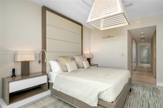 bedroom featuring visible vents and wood finished floors