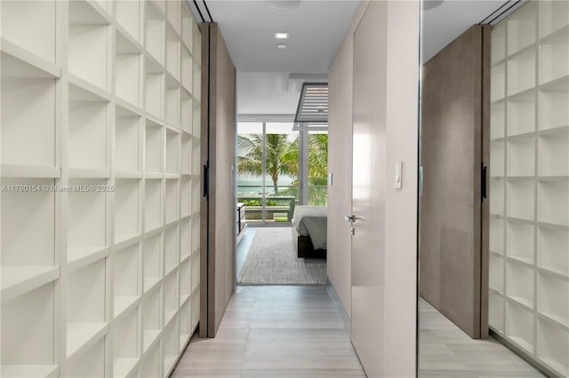 321 Ocean Dr Unit 200, Miami Beach, FL 33139 - hallway featuring expansive windows and light wood-style flooring