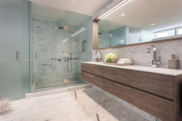 bathroom featuring double vanity, marble finish floor, a marble finish shower, and a sink