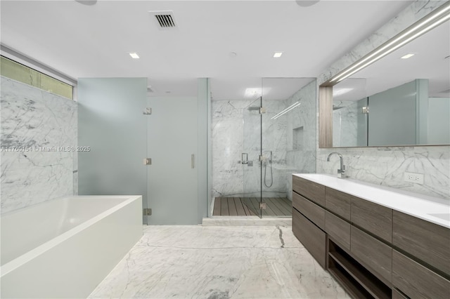 full bathroom with visible vents, a sink, a marble finish shower, double vanity, and a bath