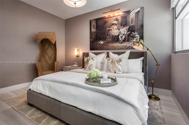 bedroom with wood finished floors and baseboards