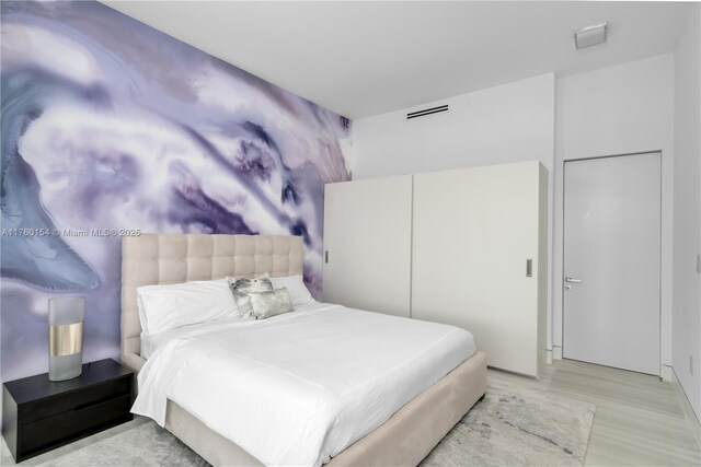 321 Ocean Dr Unit 200, Miami Beach, FL 33139 - bedroom featuring visible vents and light wood finished floors