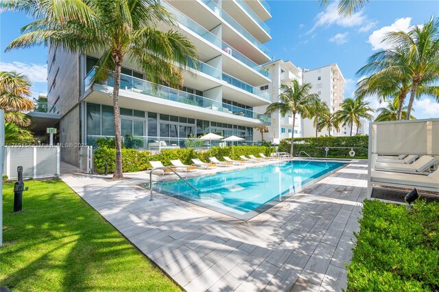 321 Ocean Dr Unit 200, Miami Beach, FL 33139 - community pool with fence, a patio area, and a lawn