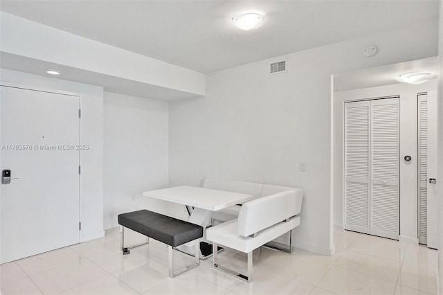 dining area with light tile patterned floors, visible vents, and baseboards