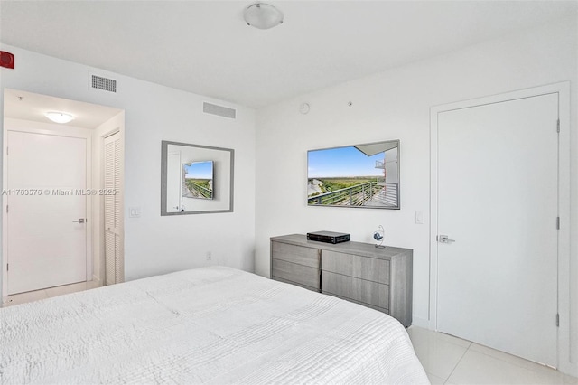 bedroom featuring light tile patterned floors and visible vents