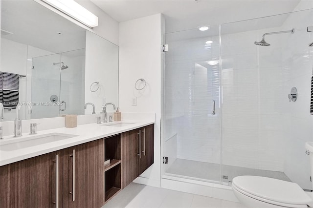 bathroom with tile patterned flooring, a stall shower, and a sink