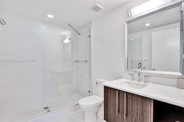 full bath featuring vanity, a shower stall, toilet, and visible vents