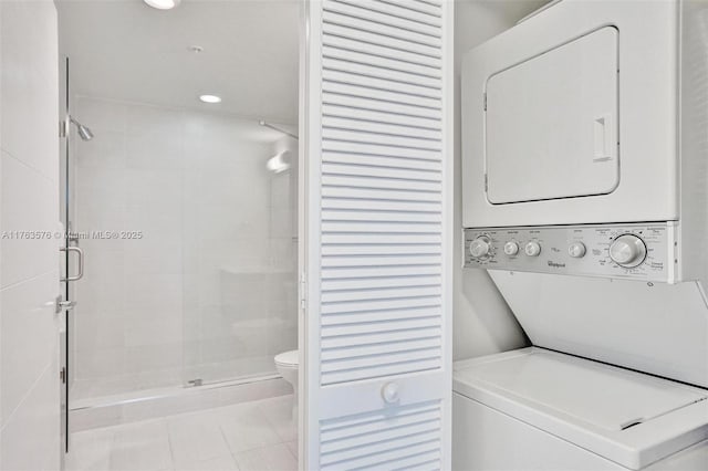 laundry room with laundry area, recessed lighting, tile patterned floors, and stacked washing maching and dryer