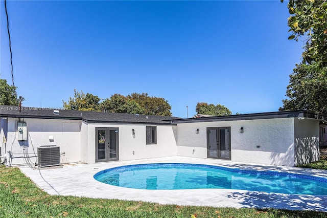 back of property with french doors, a patio area, cooling unit, and stucco siding