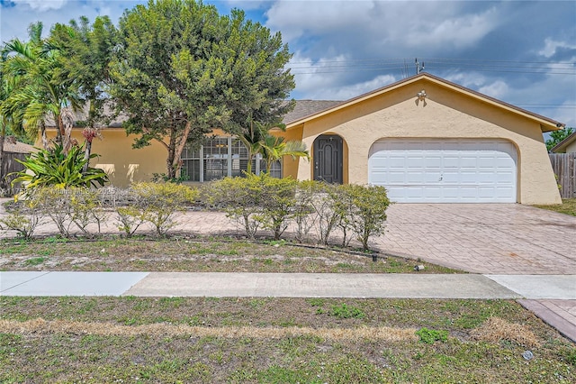 1281 Wyndcliff Dr, Wellington, FL 33414 - view of front of house with stucco siding, decorative driveway, and an attached garage