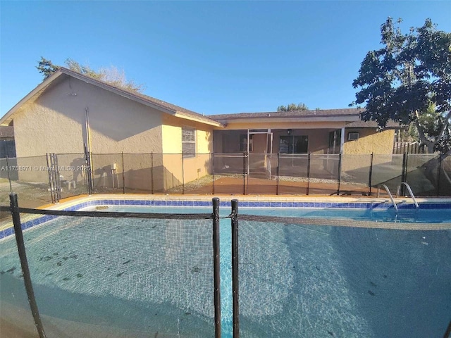 view of swimming pool with a fenced in pool and fence