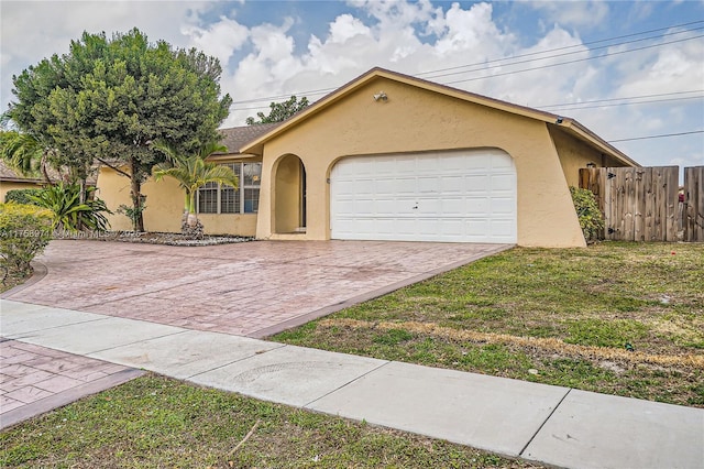1281 Wyndcliff Dr, Wellington, FL 33414 - view of front of property with stucco siding, a front lawn, decorative driveway, fence, and a garage