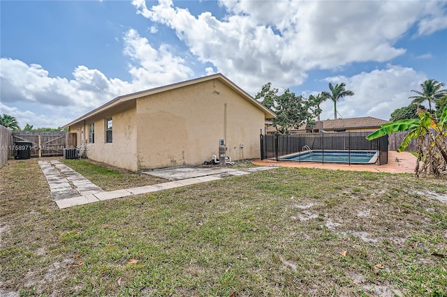 1281 Wyndcliff Dr, Wellington, FL 33414 - view of yard with a patio area, a fenced in pool, cooling unit, and a fenced backyard
